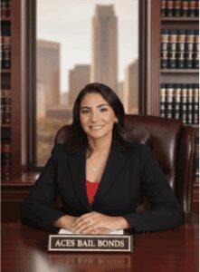 Smiling woman at desk, Aces Bail Bonds.